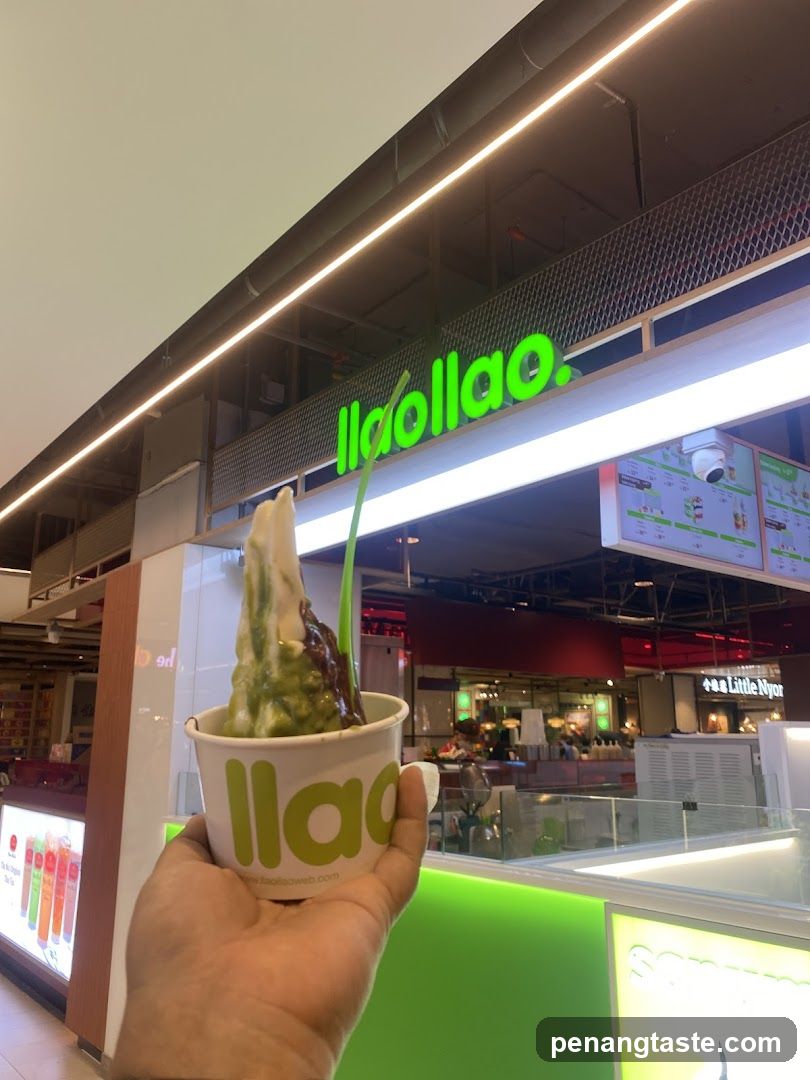 Hand holding ice cream in front of llao llao storefront