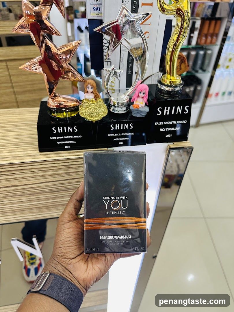 Hand holding perfume box in store