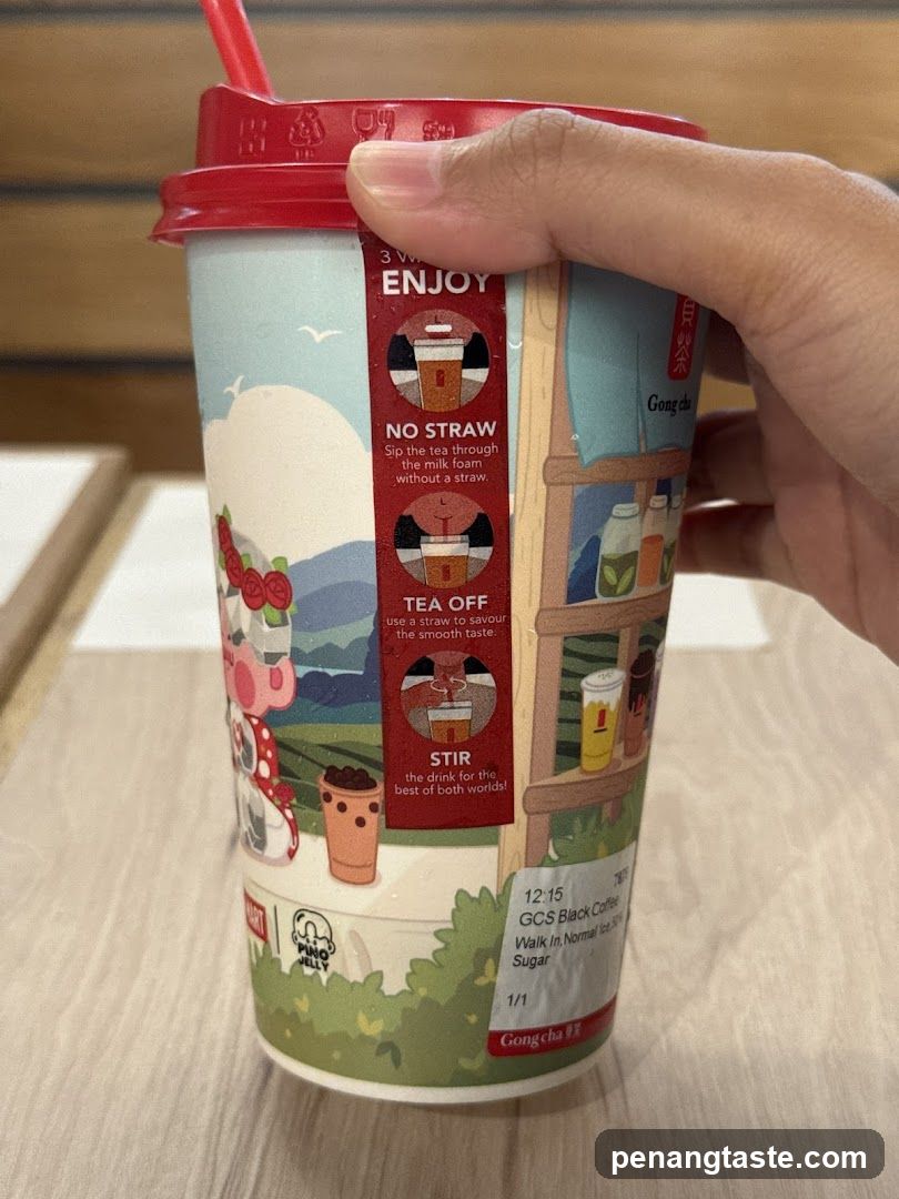Hand holding Gong cha drink cup