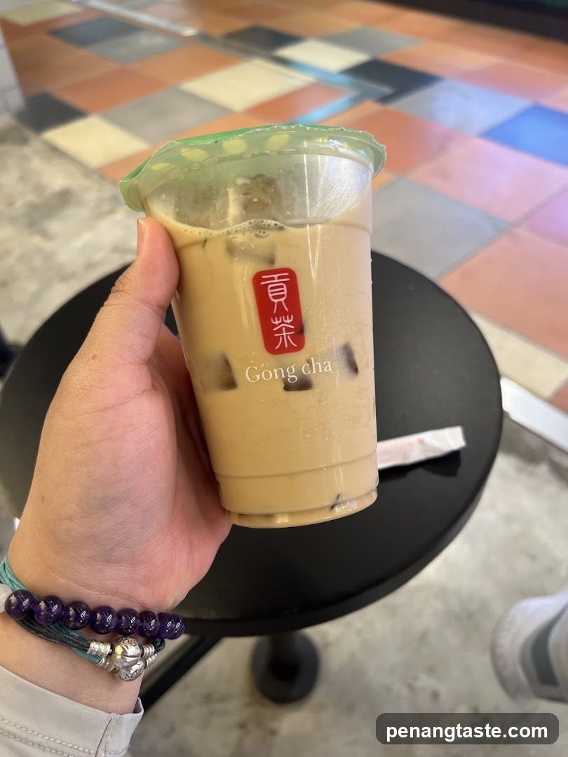 Hand holding Gong Cha iced tea