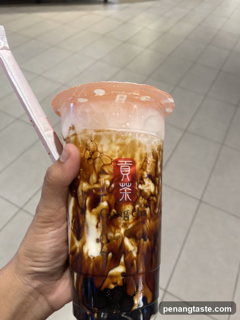 Hand holding Gong Cha drink