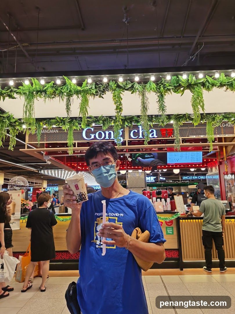 Person holding bubble tea in shopping mall