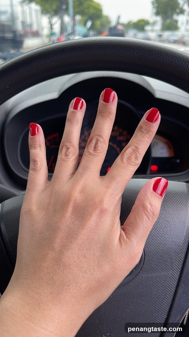 Hand with red nails in car