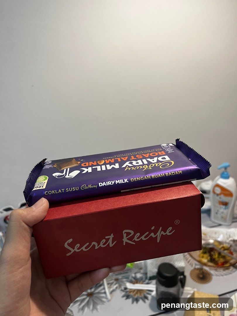 Hand holding chocolate bar and box
