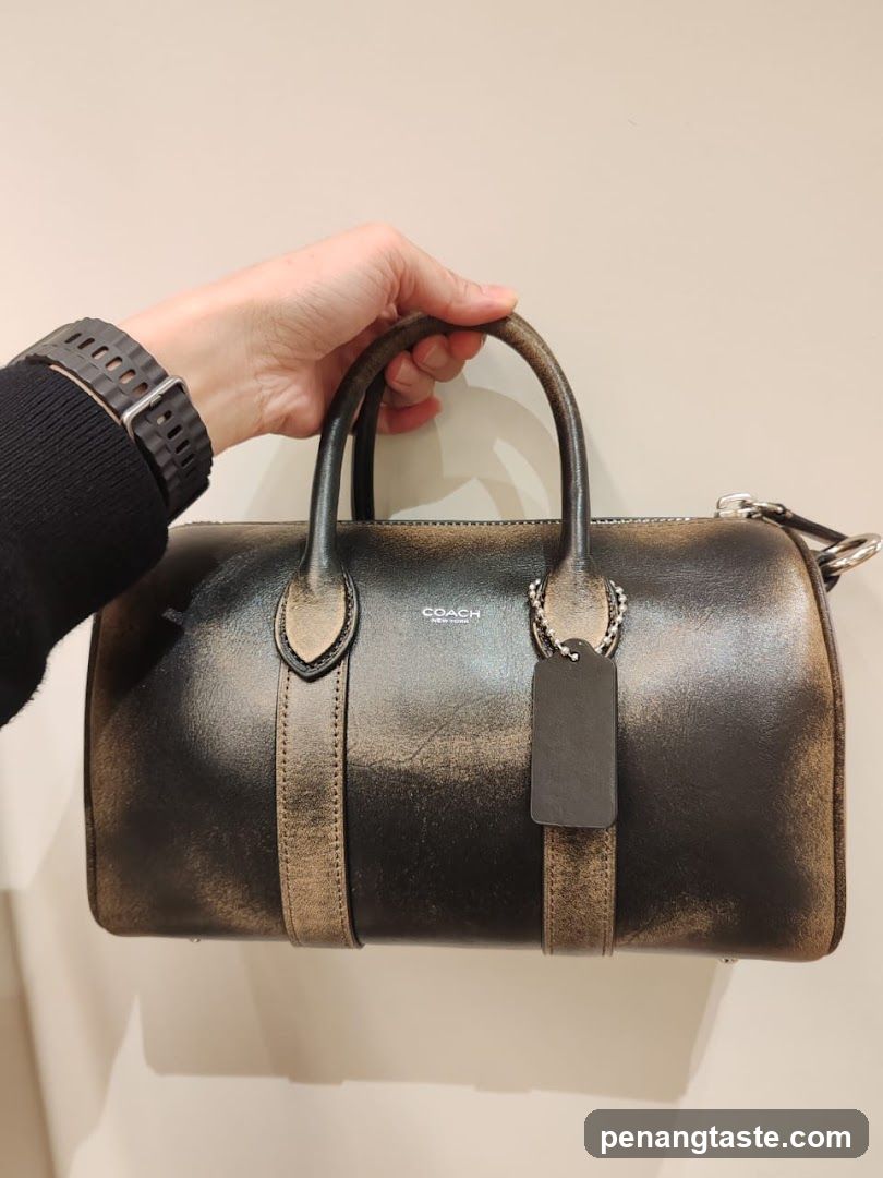 Hand Holding Coach Bag