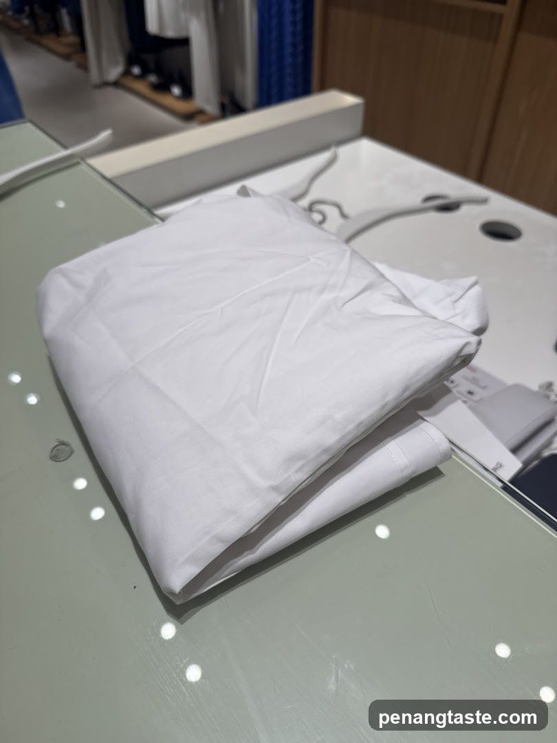 Folded white garment on display table