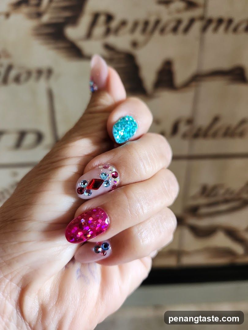 Hand with Glitter and Gemstone Nails