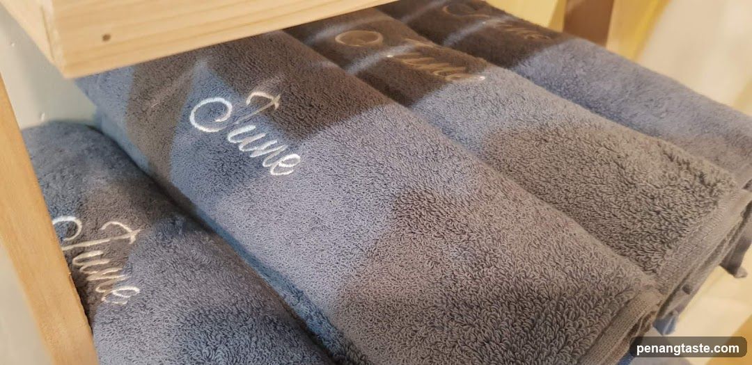Folded Towels with Embroidered Text
