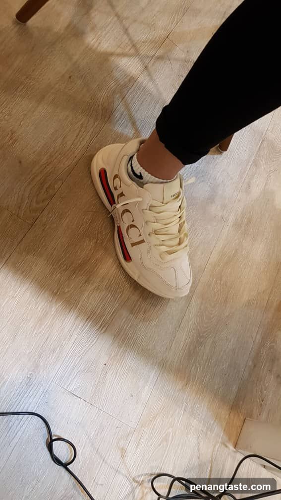Person wearing Gucci sneakers