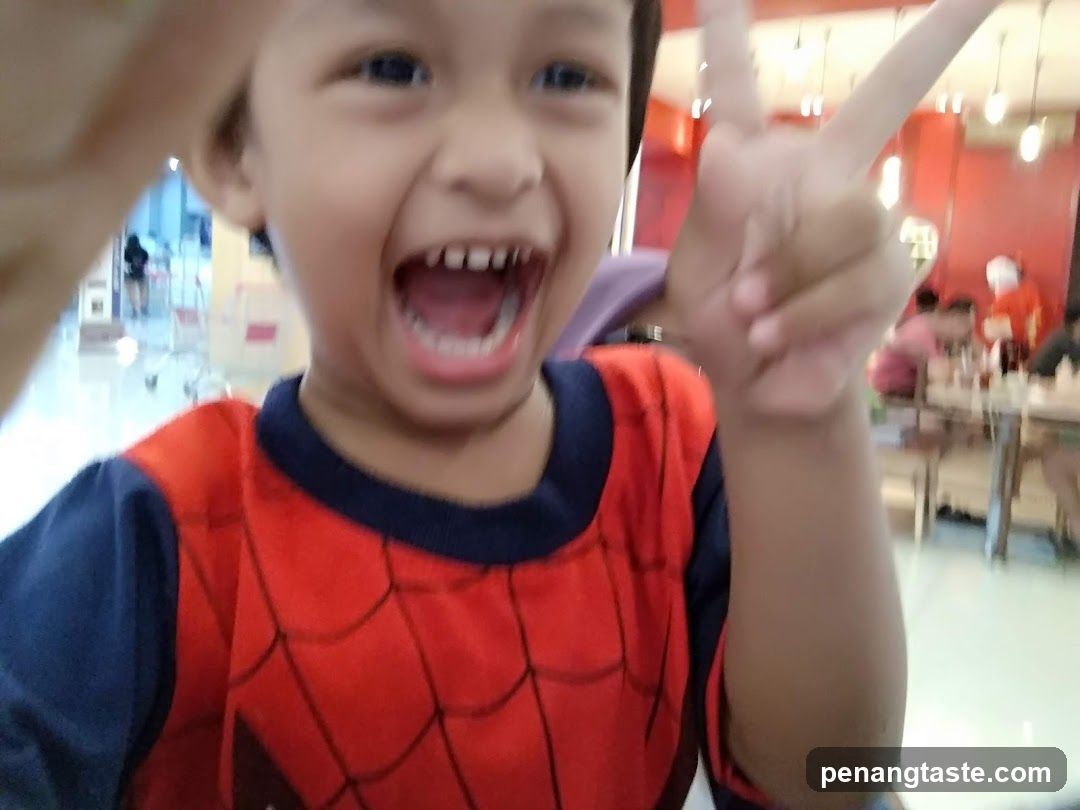 Child in Spider-Man costume at food court