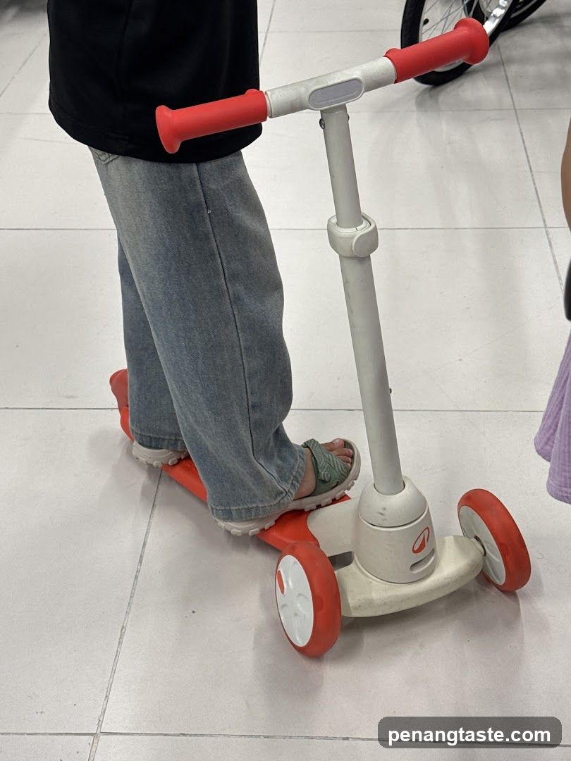 Child on scooter indoors
