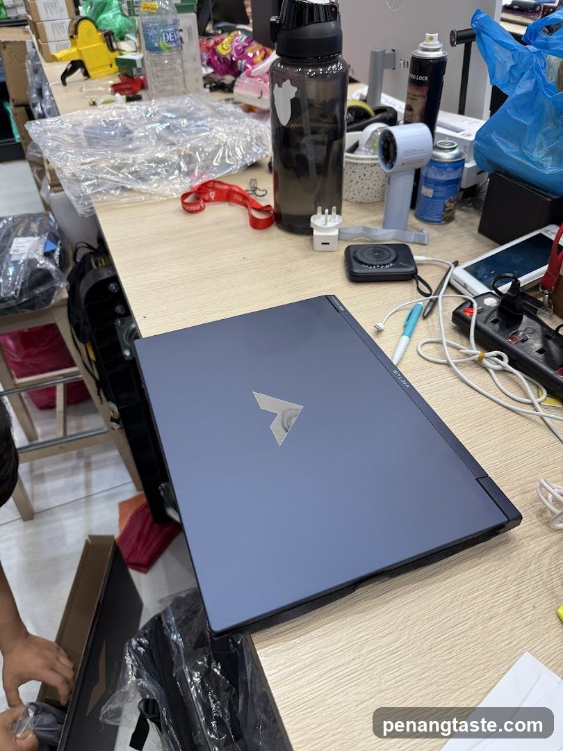 Laptop on cluttered desk