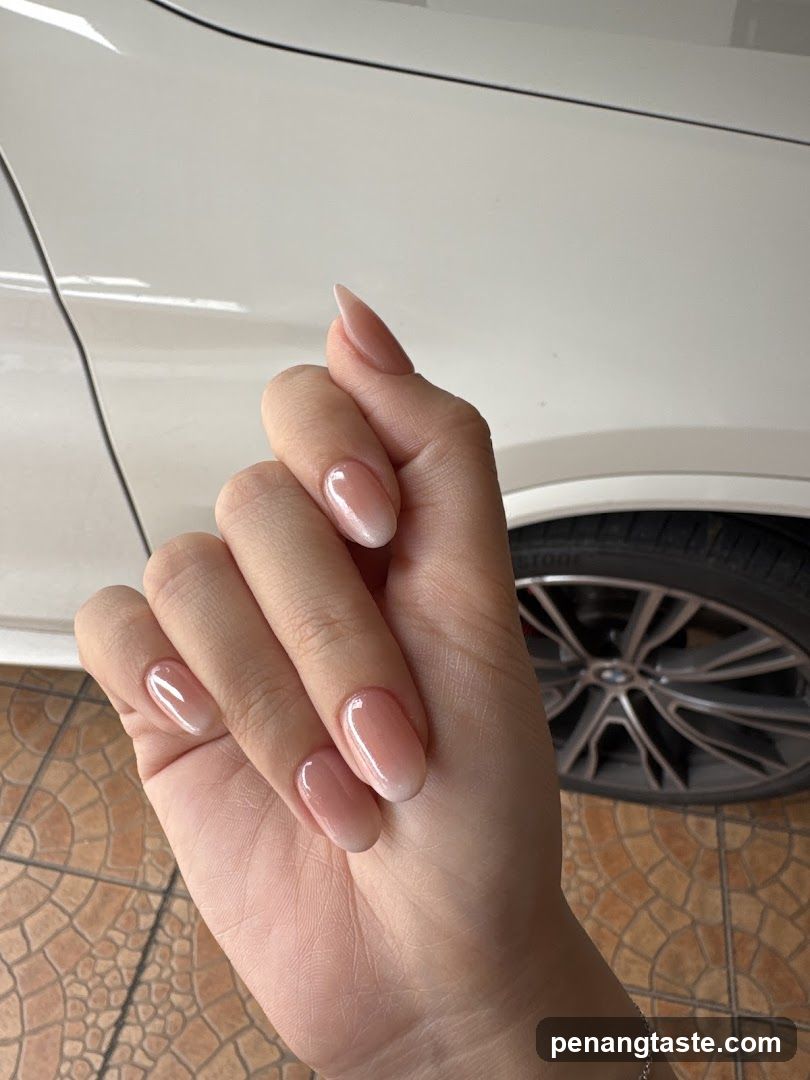 Hand with manicure in front of car