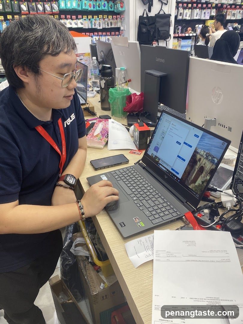 Employee at workstation in electronics store