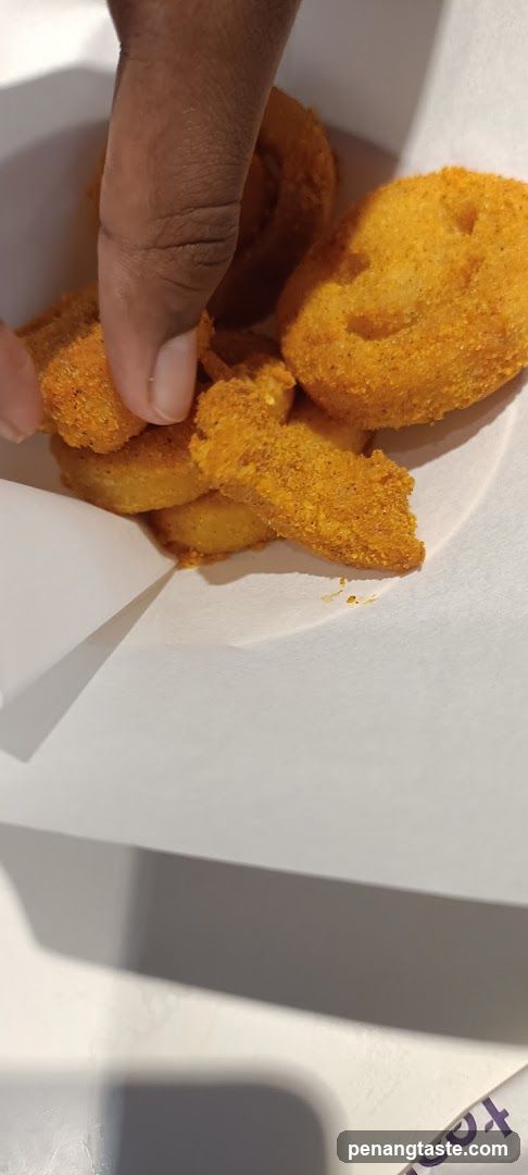 Hand holding fried food items