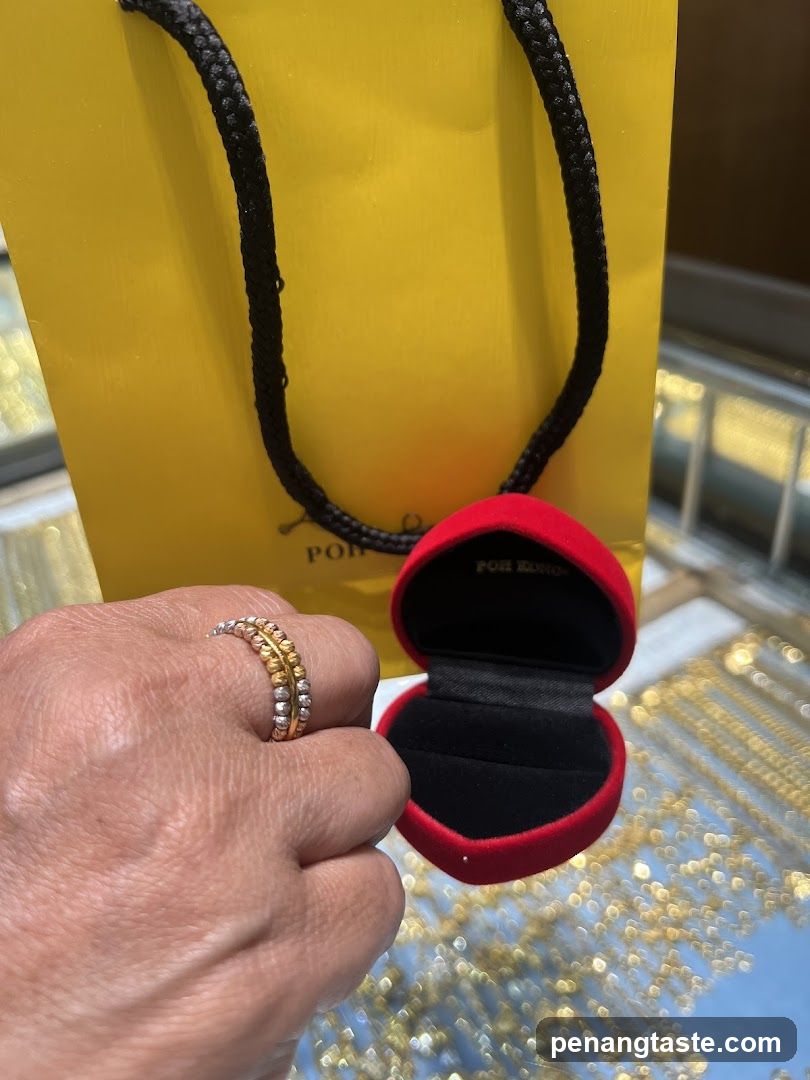 Hand holding ring and jewelry box with shopping bag