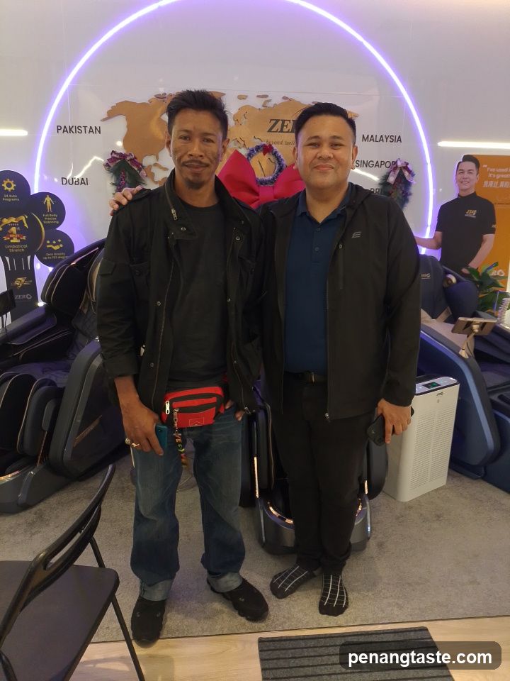 Two men posing in a showroom