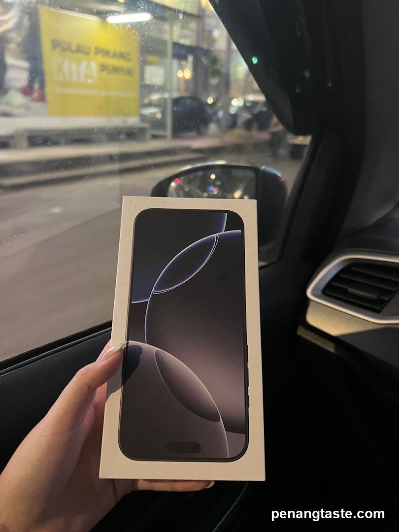 Hand holding smartphone box inside car
