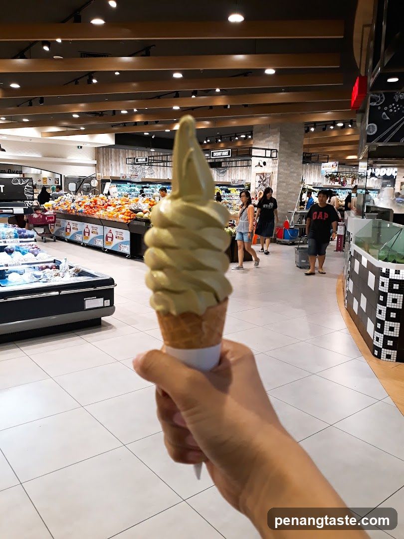 Hand holding soft serve ice cream in supermarket
