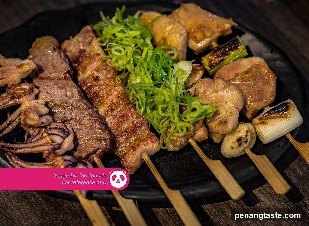 Grilled skewers on a black plate