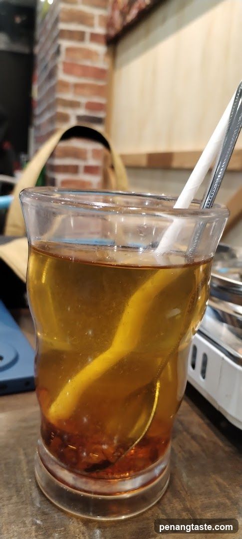 Tea drink in glass with straws