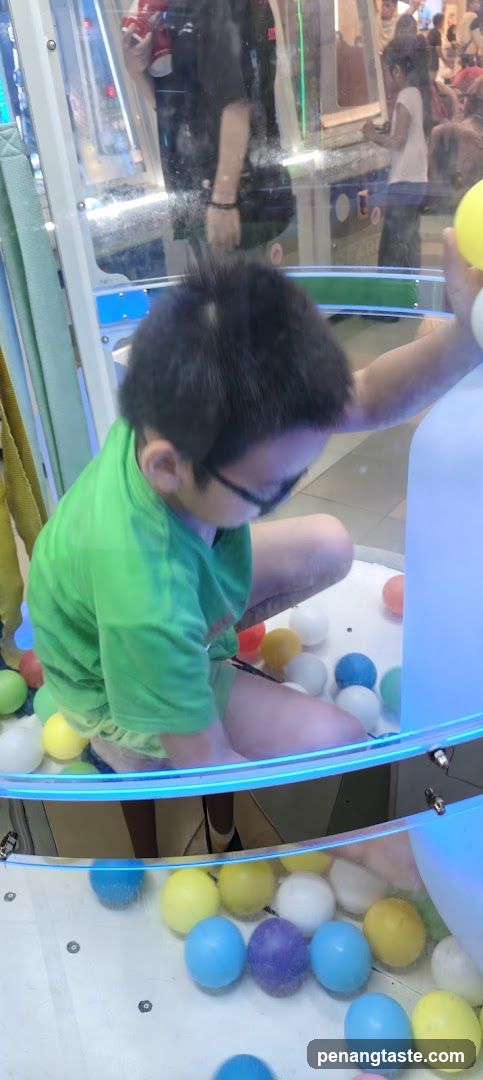 Child playing in claw machine