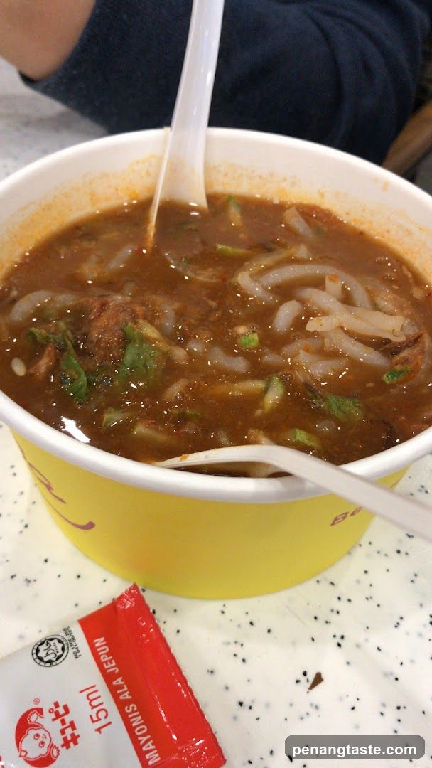 Food in a cup with condiment packet