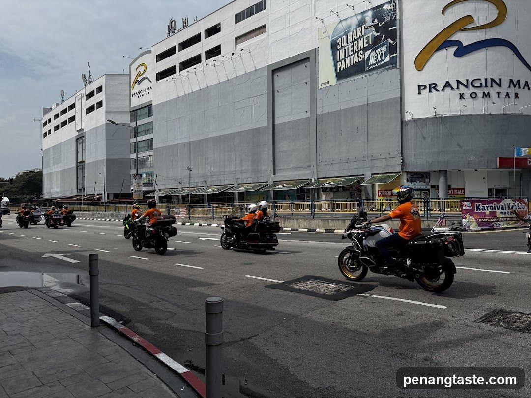 Motorcyclists on street in front of Prangin Mall