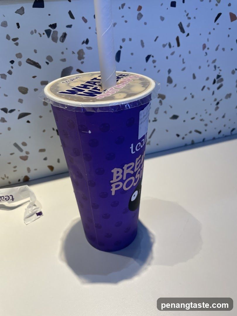 Purple beverage cup with straw
