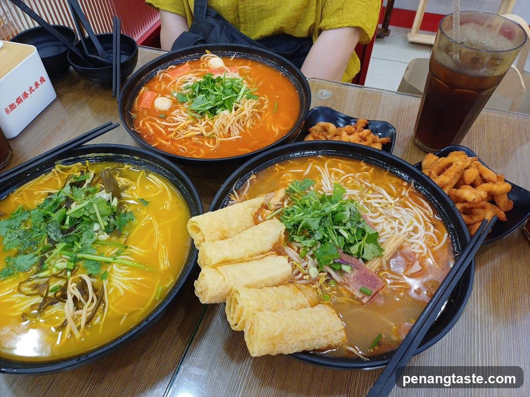 Table with noodle dishes and side dishes