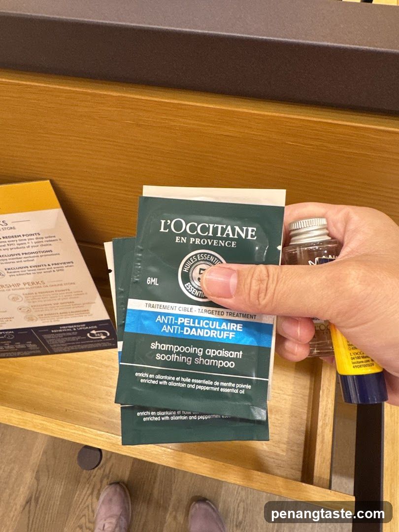 Hand holding L'Occitane product packets