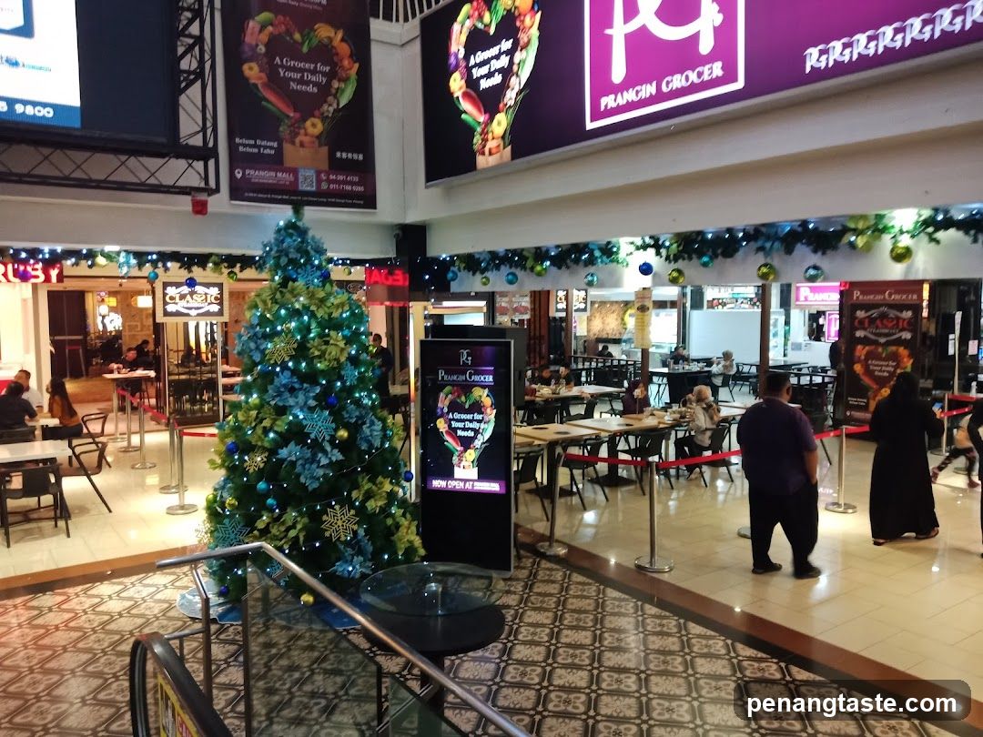 Interior of shopping mall with Christmas tree and Francin Grocer signage
