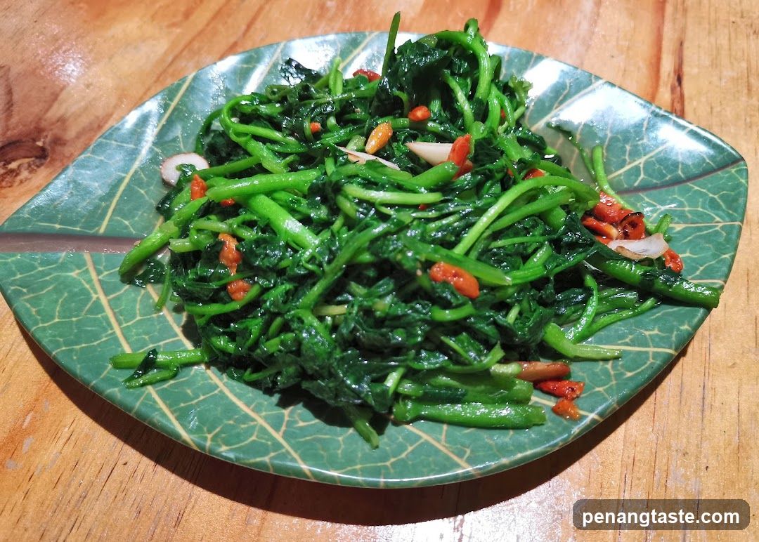 Stir-fried greens on leaf-patterned plate