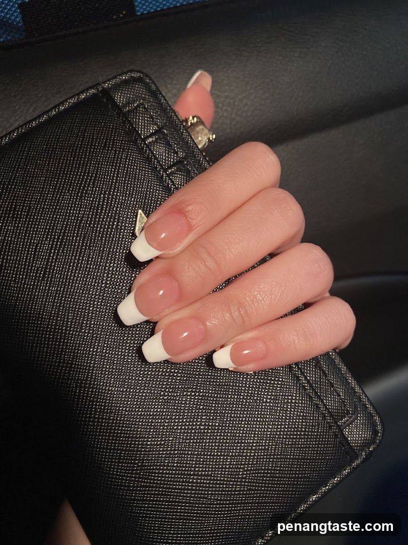 Hand with manicure holding black bag