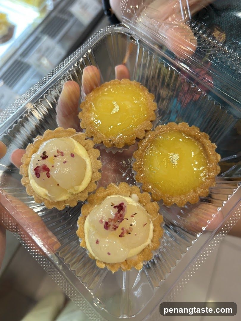 Hand holding dessert tarts in plastic container