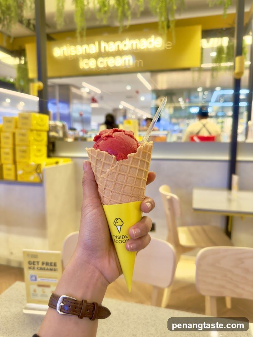 Hand holding ice cream cone in store