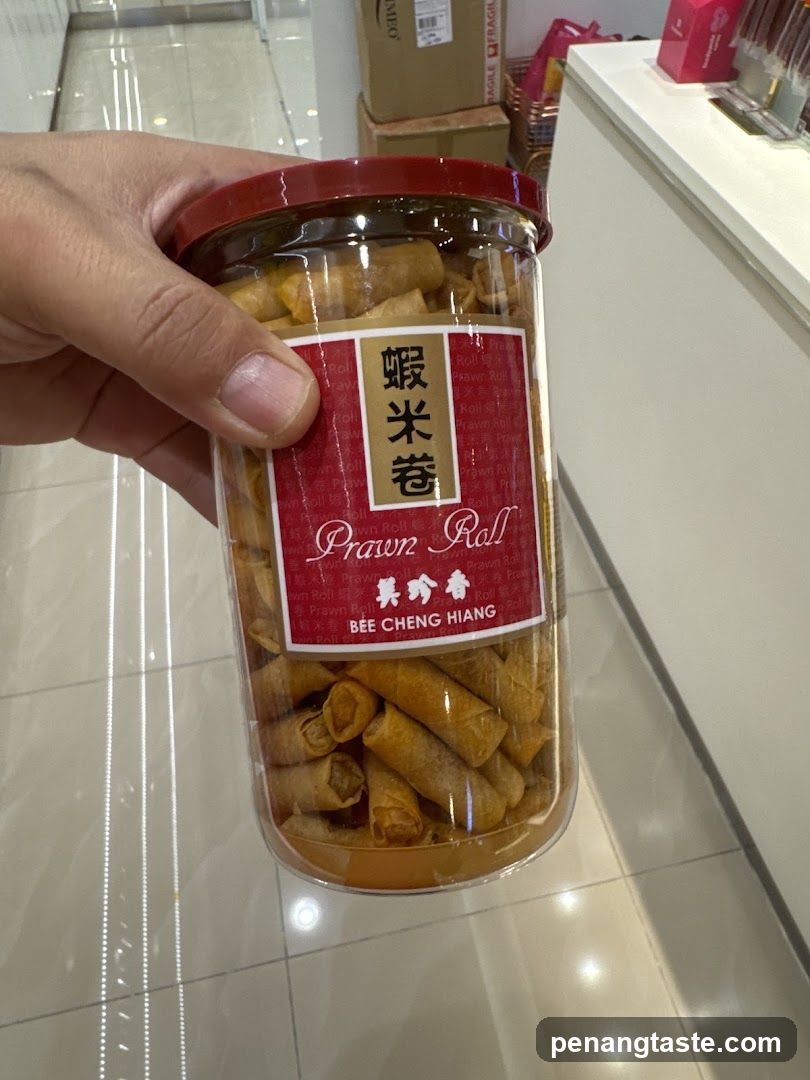 Hand holding jar of prawn rolls