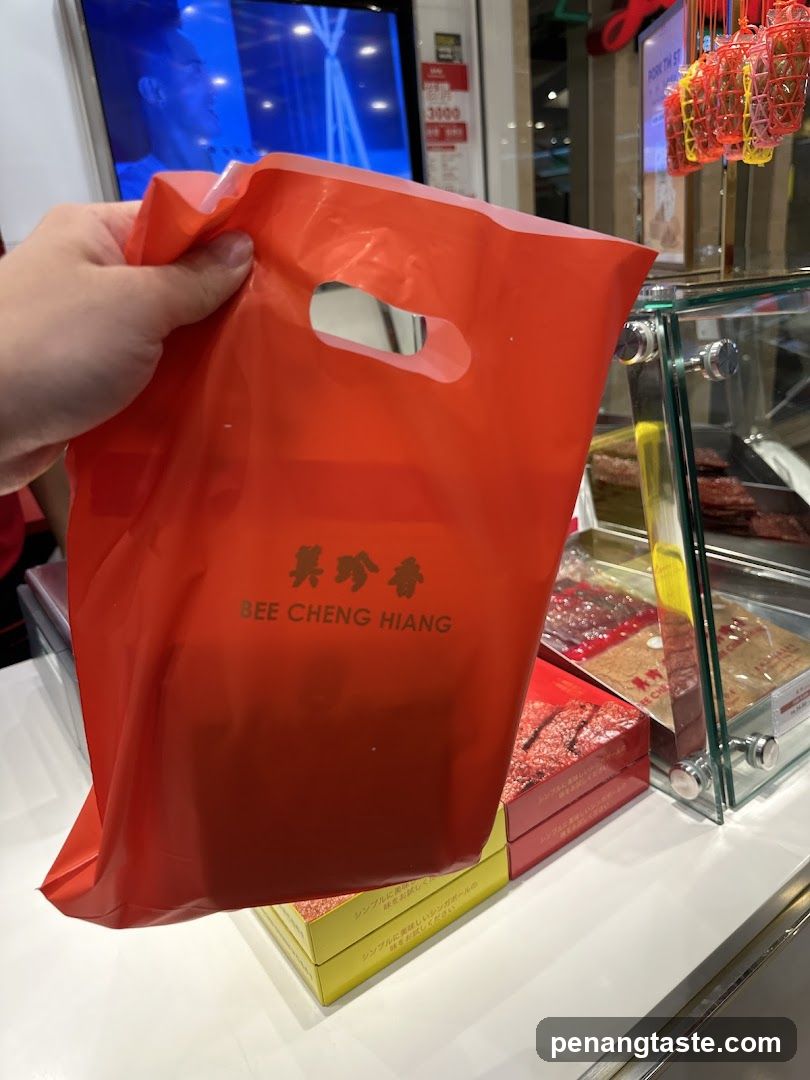 Hand holding red shopping bag