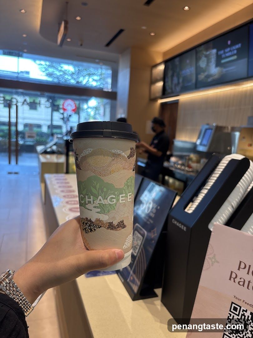 Customer holding Chagee cup inside store
