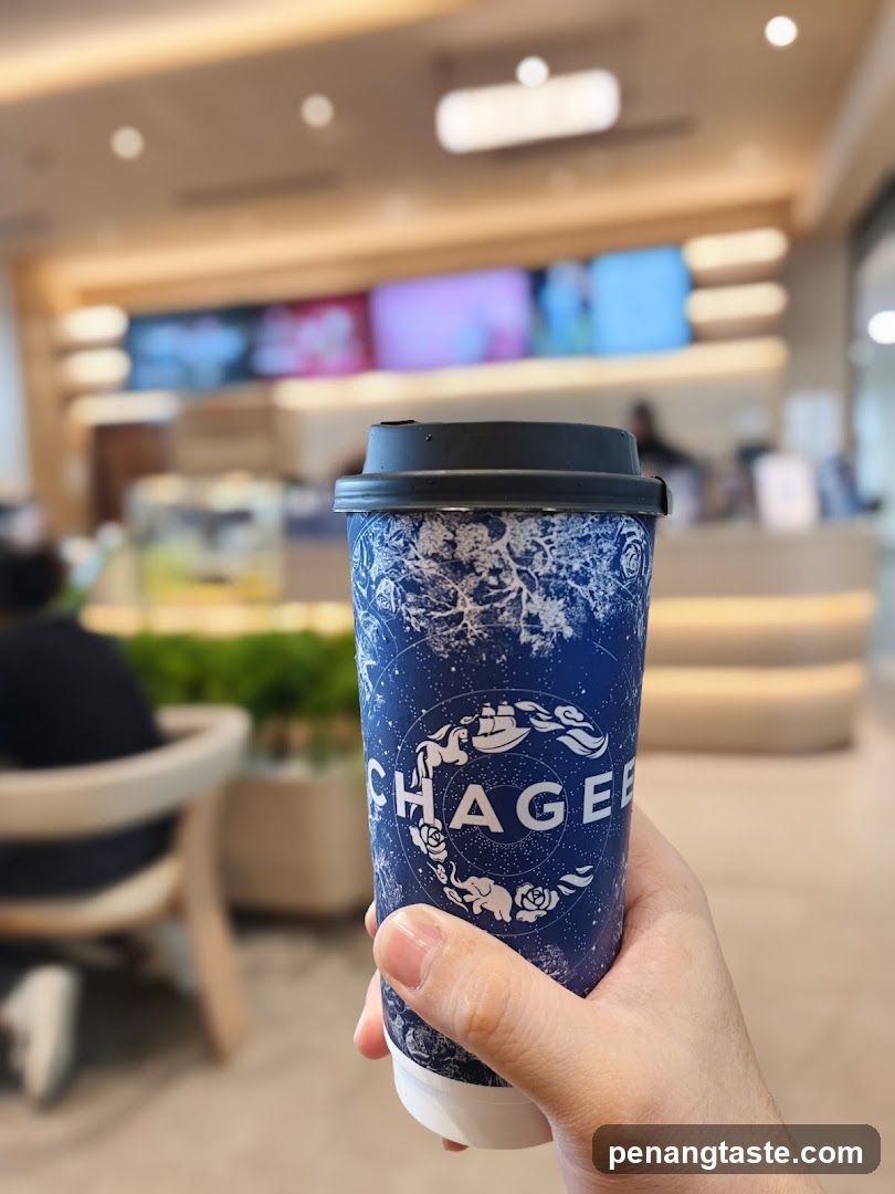 Hand holding branded coffee cup