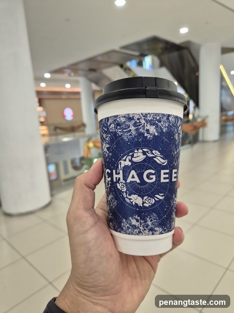 Hand holding Chagee coffee cup
