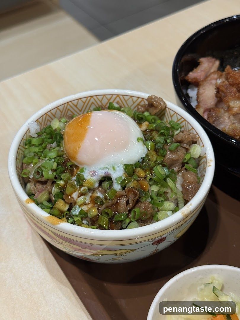 Bowl of rice dish with egg and garnish