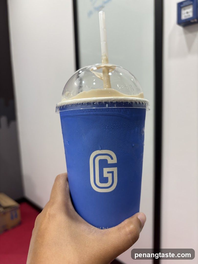 Hand holding beverage cup