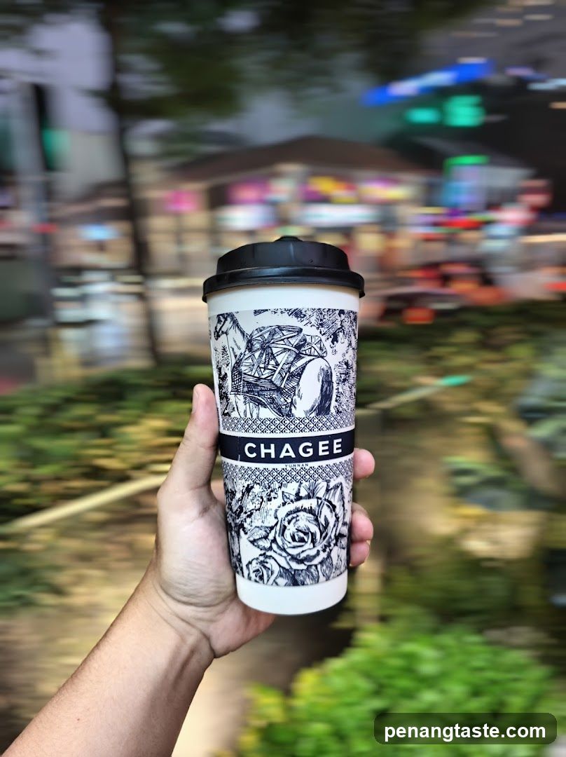 Hand holding branded coffee cup