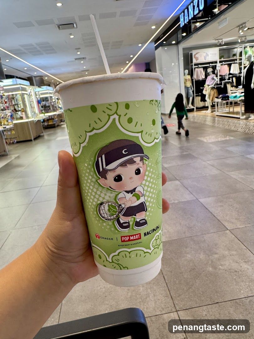Hand holding drink cup in shopping mall