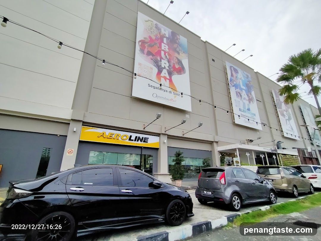 Queensbay Mall exterior with promotional banners