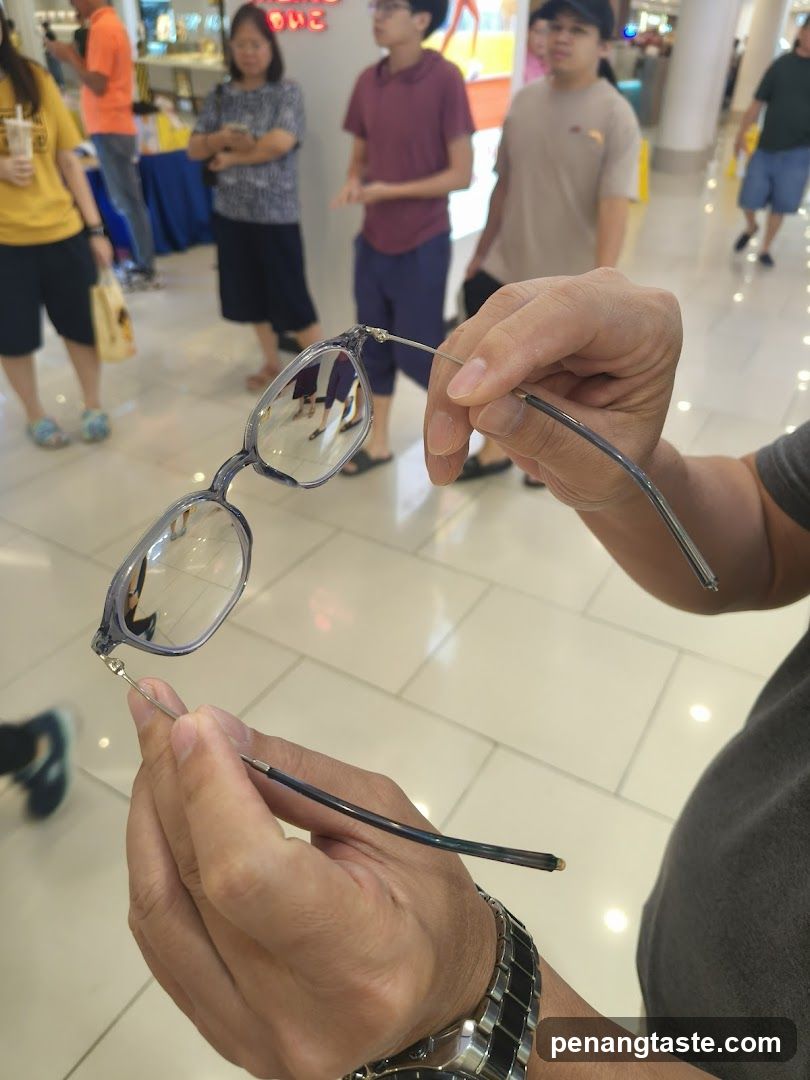 Person holding glasses in mall