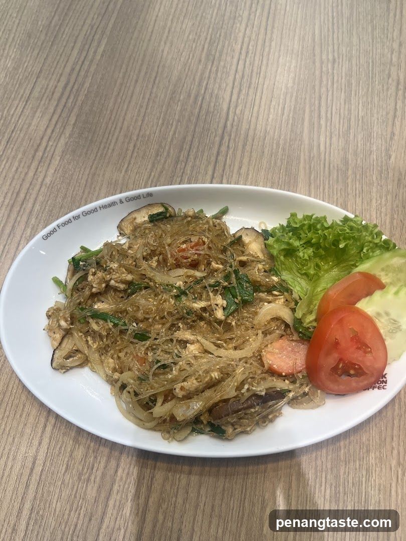 Stir-fried noodles with vegetables and salad