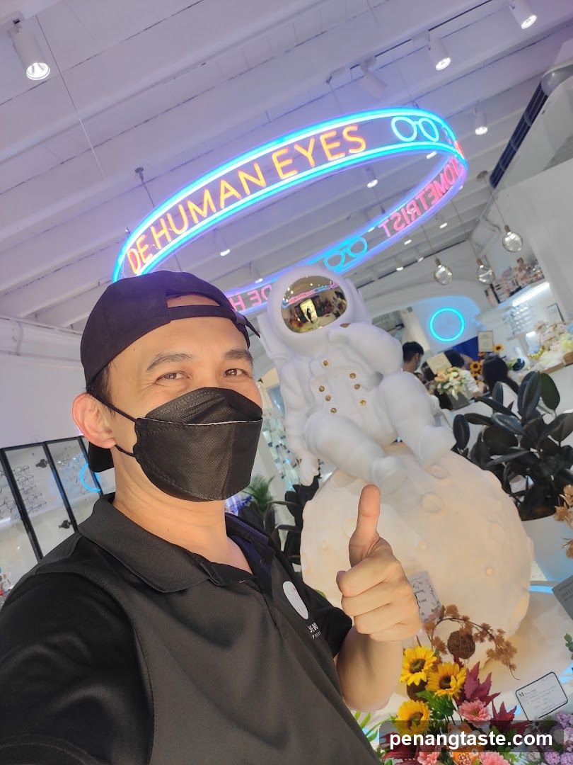 Interior photo with neon sign and astronaut display