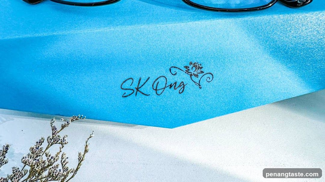 Blue surface with logo and dried plant
